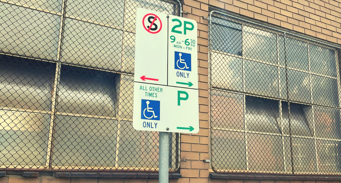 The sign next to the Parking Space for disability badge holders on Little Dryburgh Street South. Text on the sign reads: 2P 9am - 6:30pm MON-FRI, all other times Disabled Parking only..