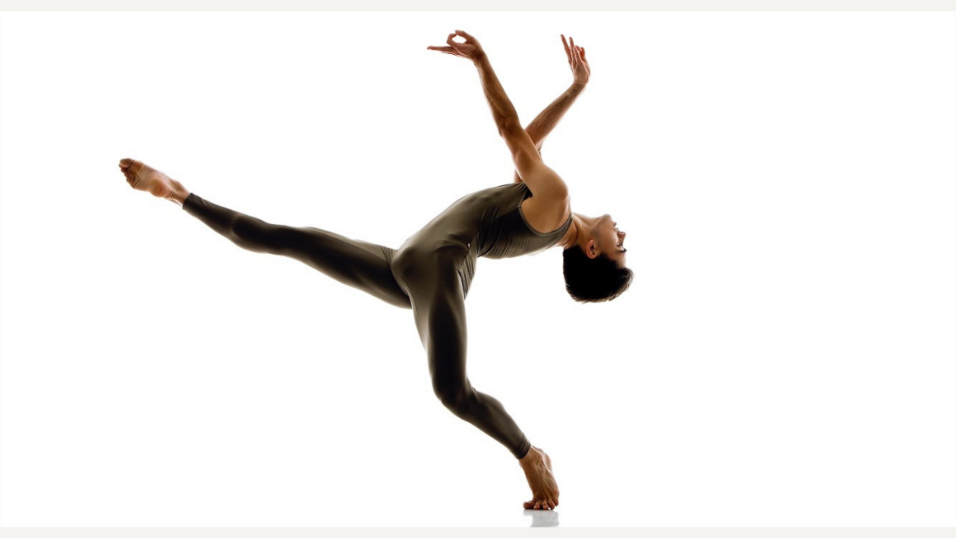 A dancer performing a ballet pose on one leg with the other extended backward.